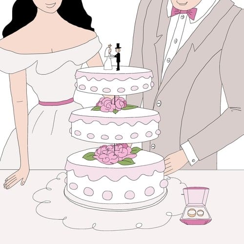 美しく装飾されたウエディングケーキの隣で幸せそうにポーズをとる新郎新婦。