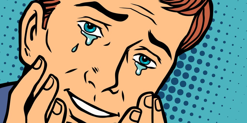 英会話中に顔に手を当てて泣いている男性。