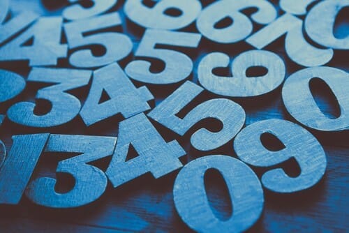 木製のテーブルに英語で書かれた青い数字のグループ。